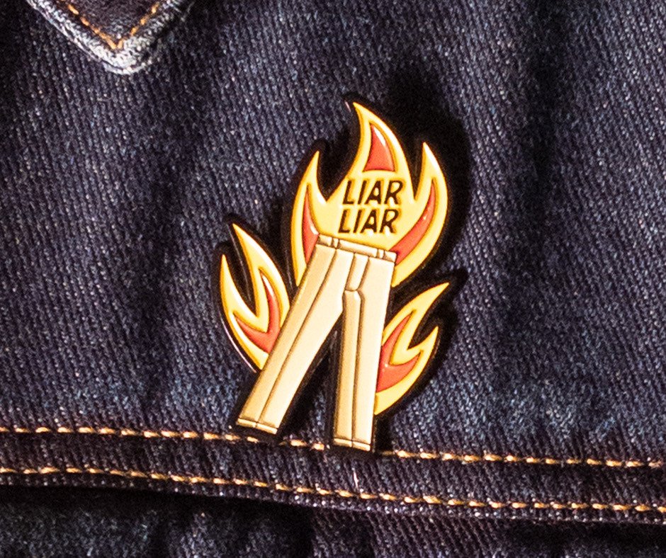 Liar Liar enamel pin worn on a denim jacket