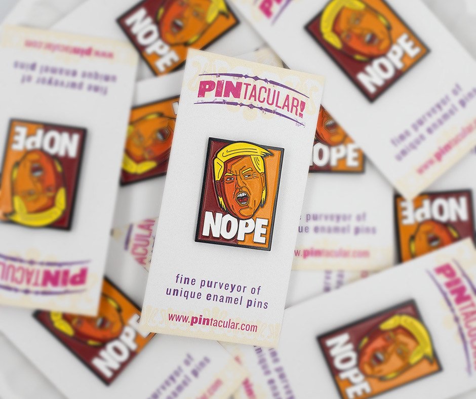 A pile of NOPE pins on printed Pintacular backing cards